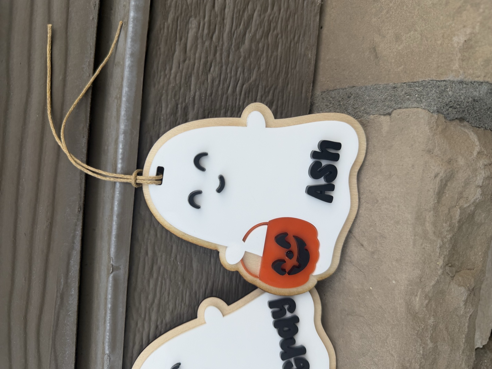 Personalized Ash ghost-shaped wooden name tag with an orange pumpkin bucket