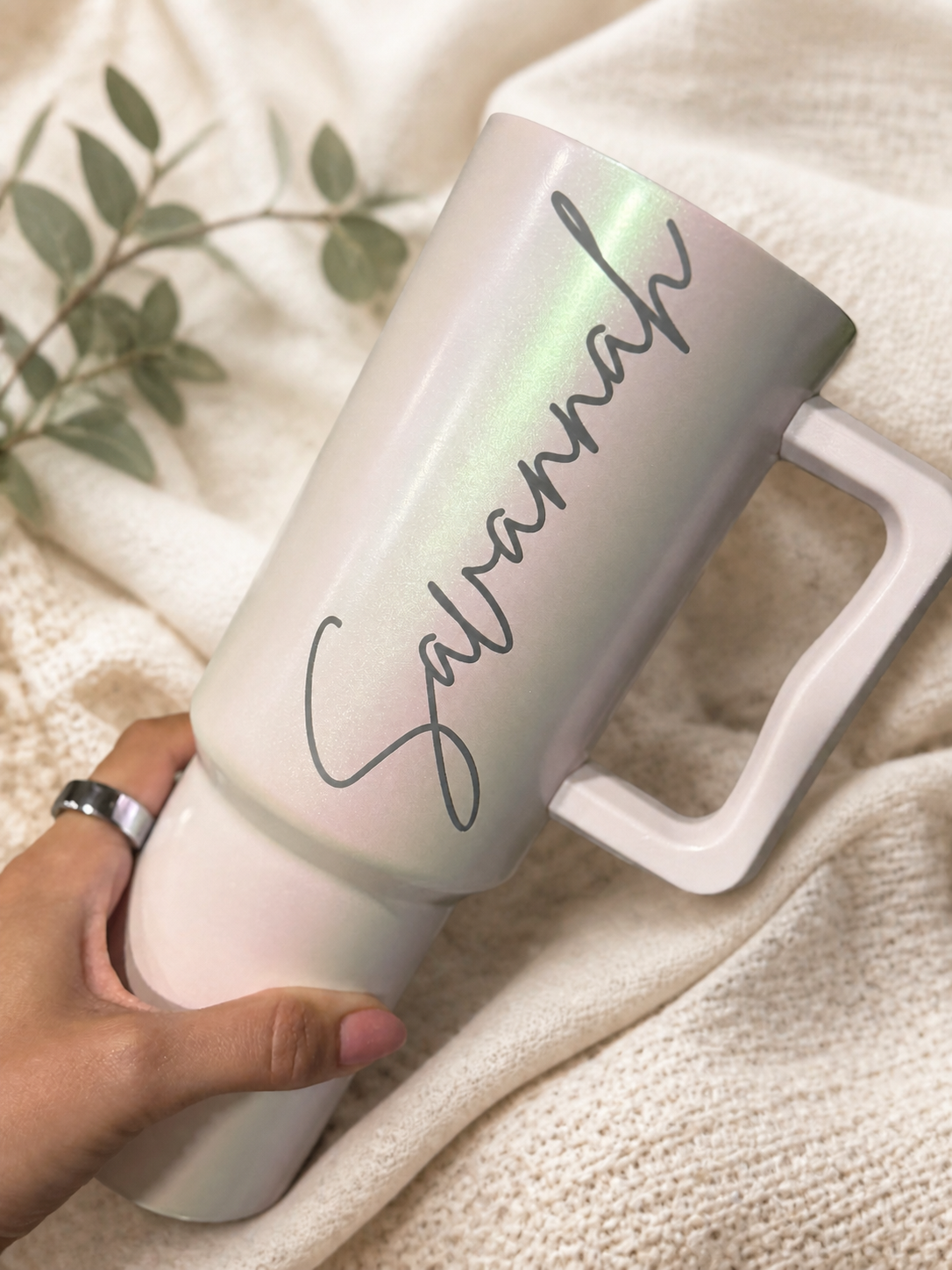 Pearlescent blush handled tumbler engraved with the name Savannah and styled on soft ivory linen