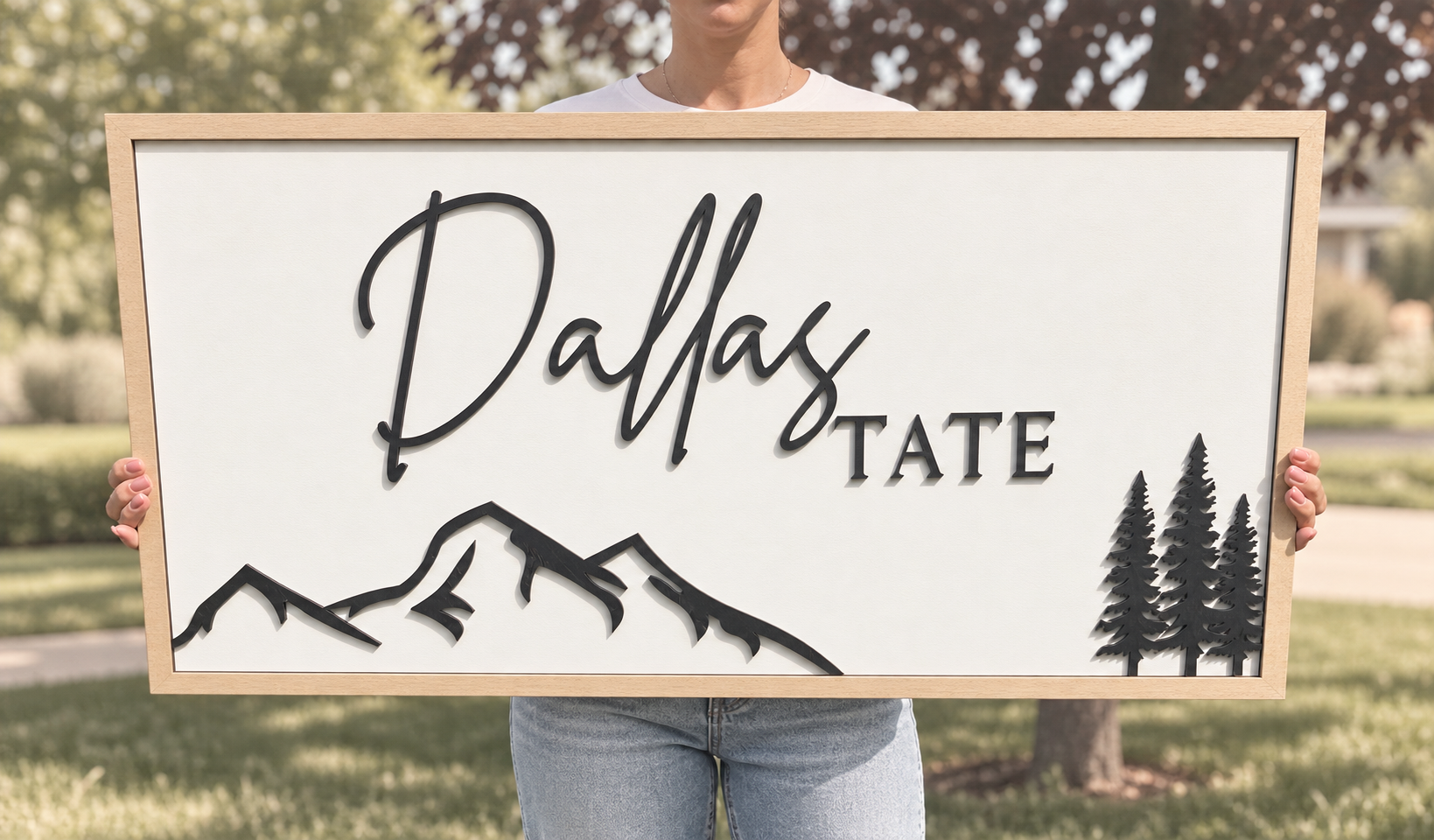 Personalized wood-framed Dallas Tate nursery sign with black mountain and evergreen tree details