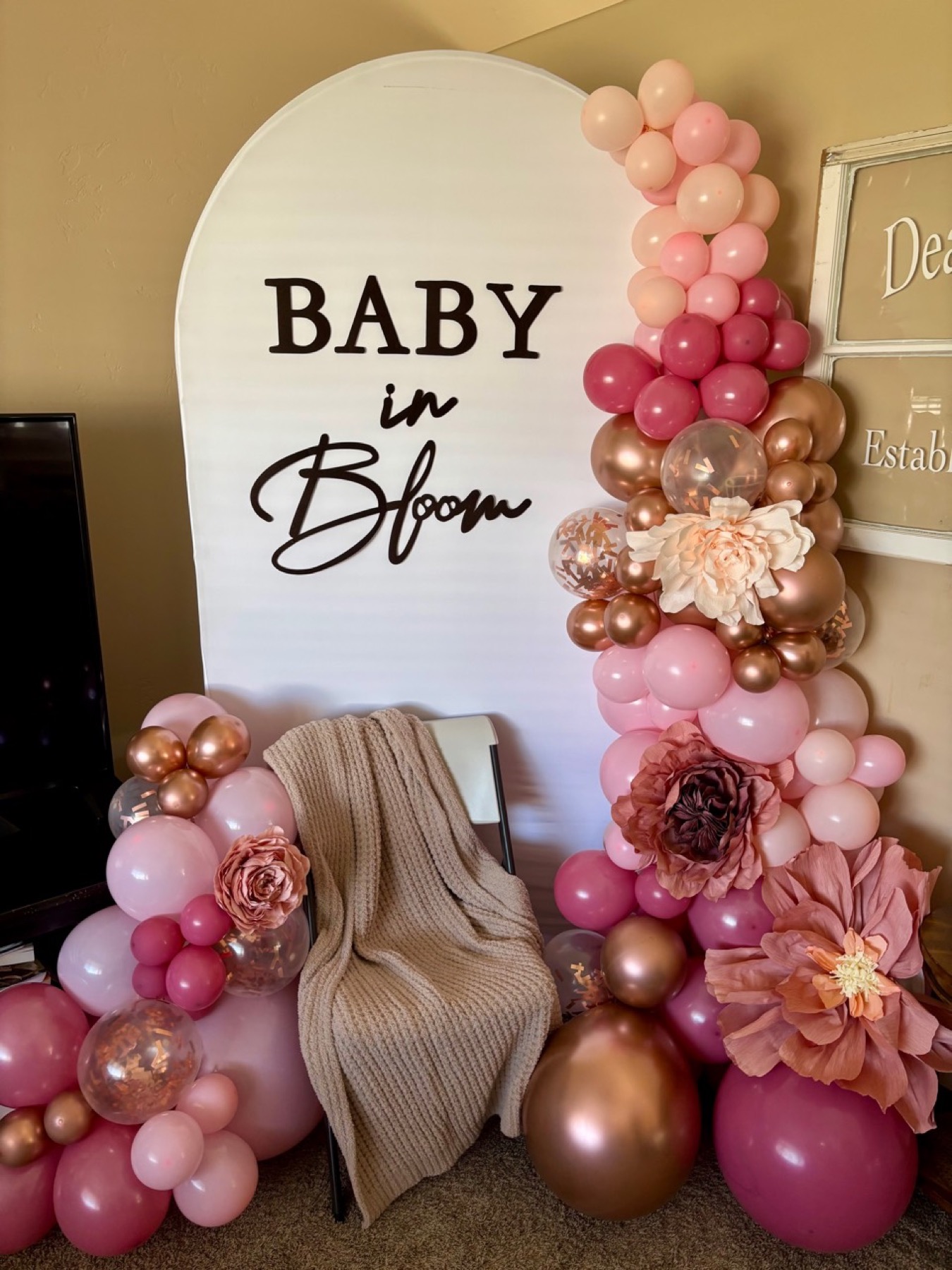 Baby in Bloom event backdrop with balloon garland and paper flowers
