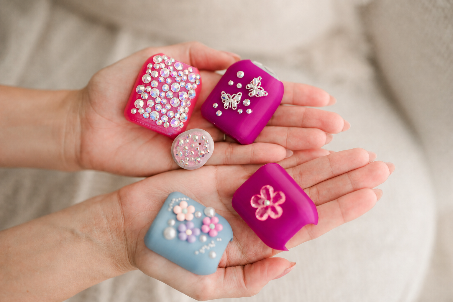Colorful jeweled medical device covers held in two hands