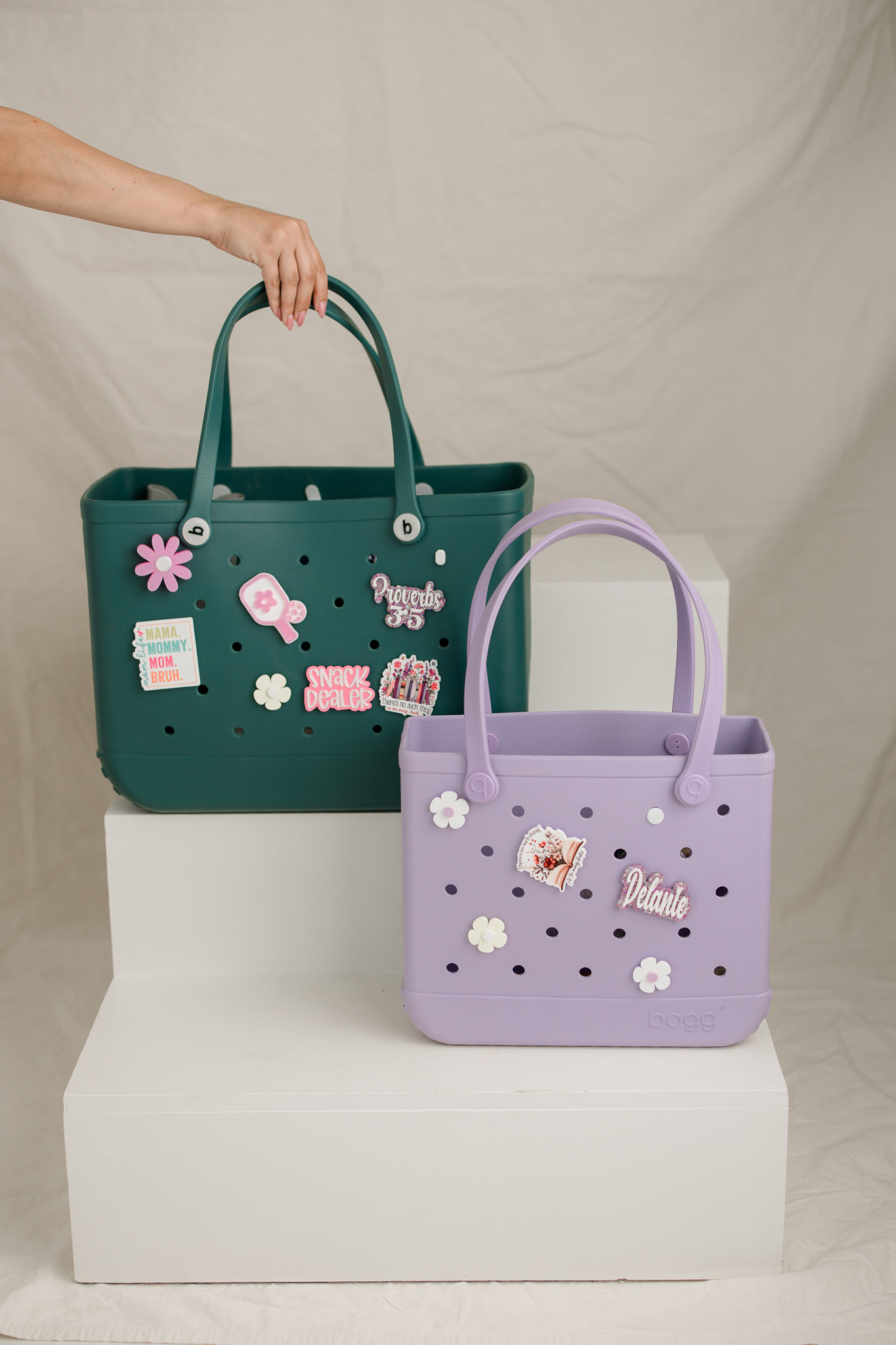 Two tote bags decorated with custom charms