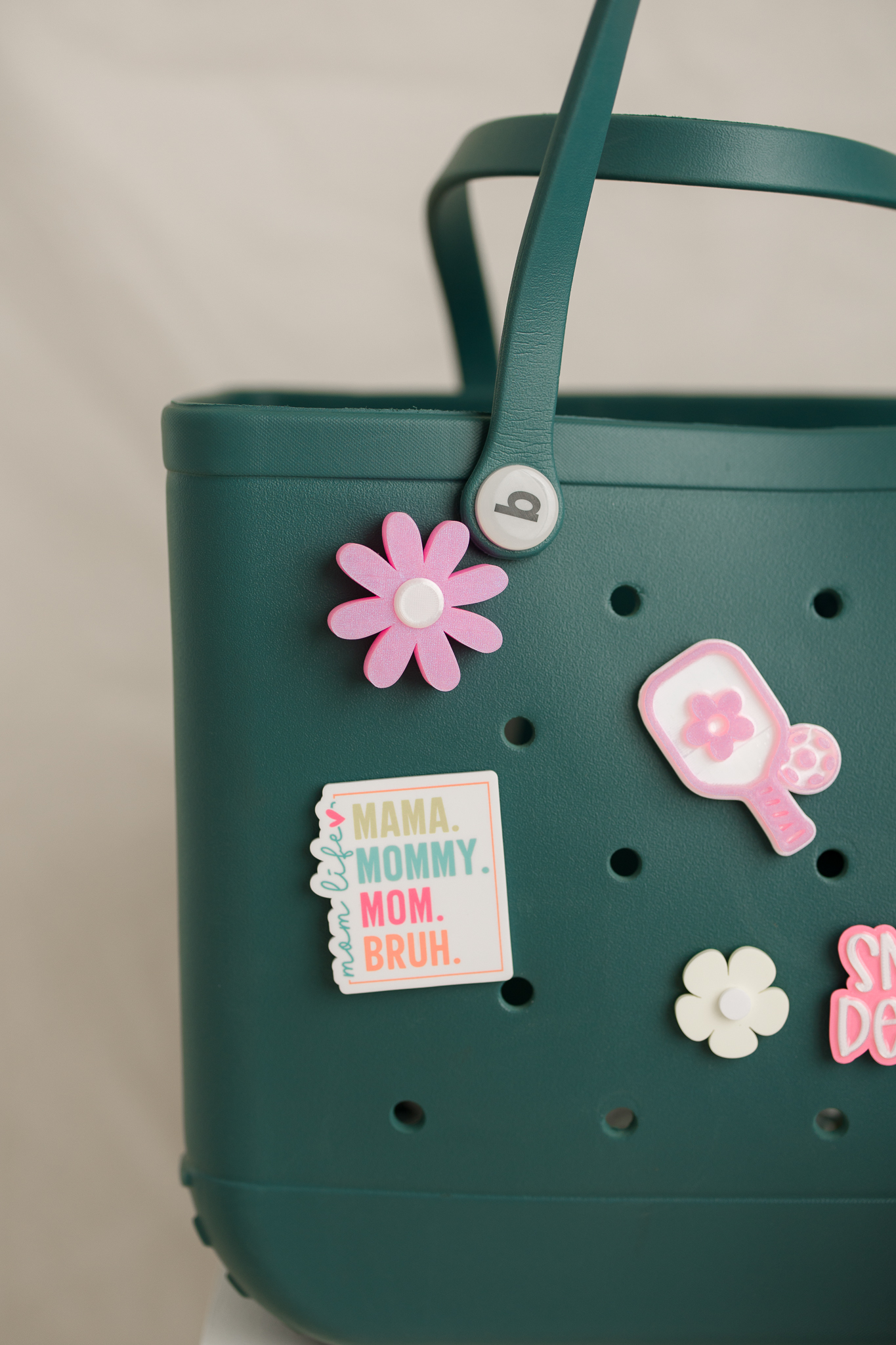 Close-up of custom charms on a green tote bag