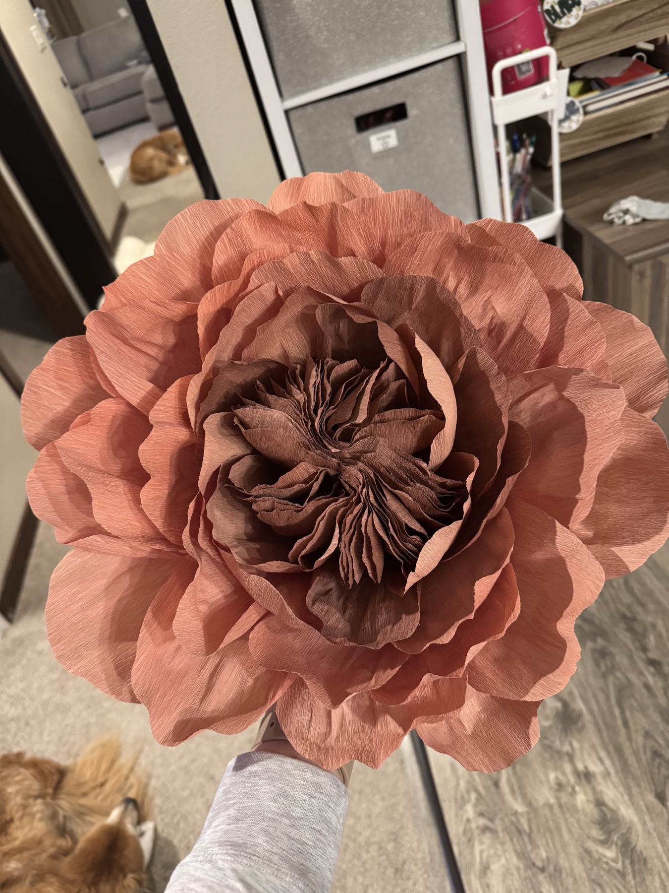 Large handmade paper flower in warm rose tones